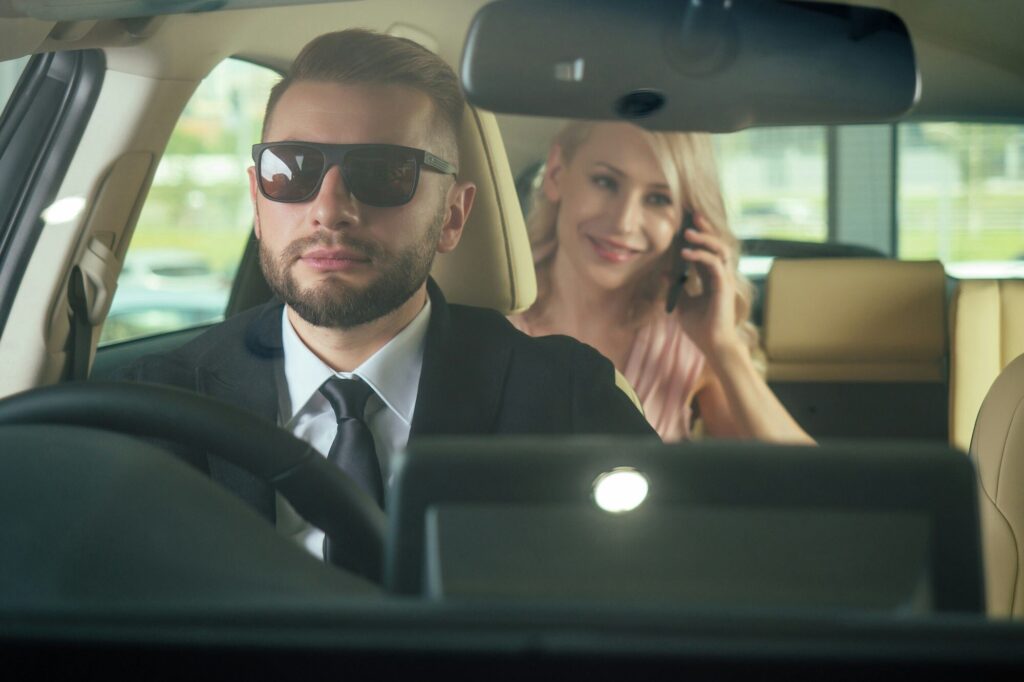 Similing driver talking with female passenger